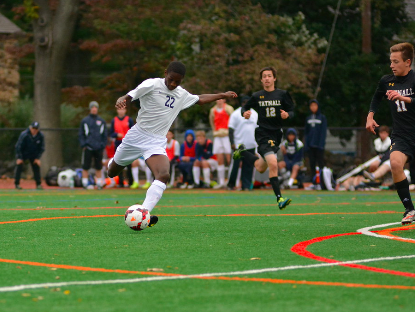 Boys Soccer player Oryem Kilama 20 skillfully shoots the ball during a game in the 2016 Fall Season