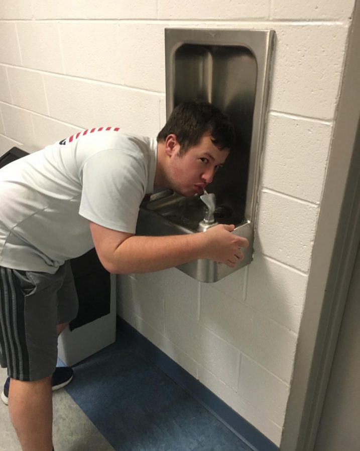 Jay Handwerk 18 drinks out of a school water fountain